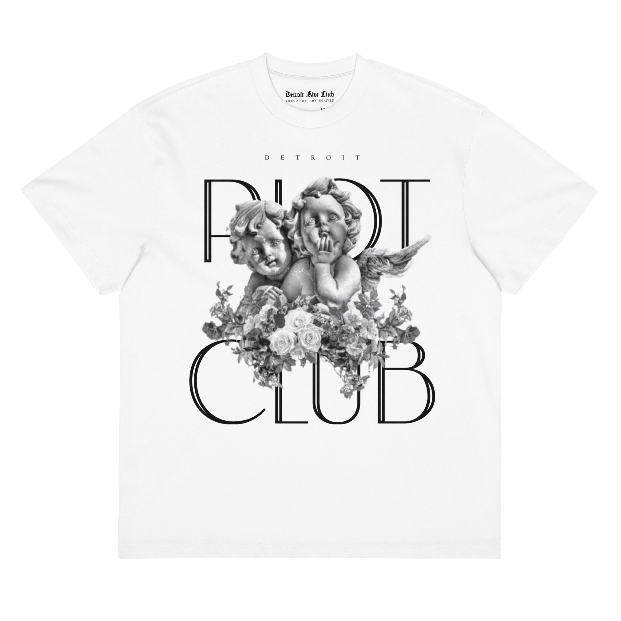 "Front flat lay of the 7oz oversized box-cut tee in optic white, showcasing the central guardian cherubs graphic and gothic 'RIOT CLUB' branding."