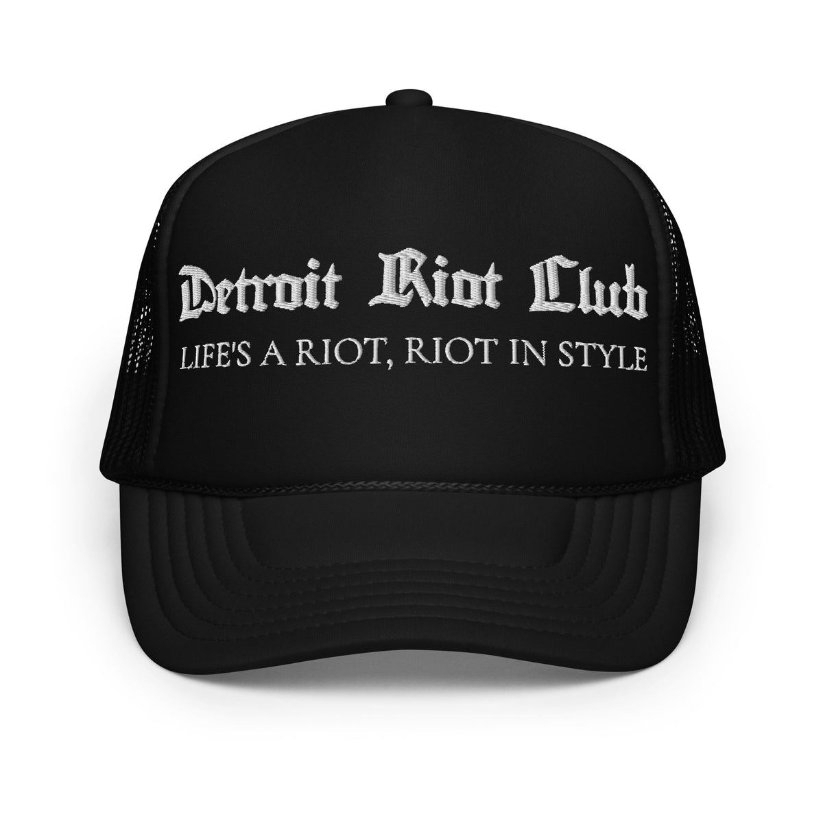 "Front view of the Detroit Riot Club Motto Foam Trucker in black. Features gothic 'Detroit Riot Club' and 'Life's A Riot, Riot In Style' archival embroidery on a structured foam front panel with mesh back."
