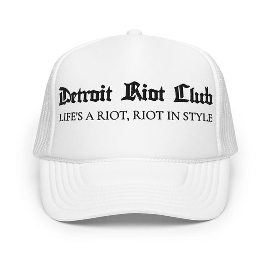 "Front view of the Detroit Riot Club Motto Foam Trucker in white. Features gothic 'Detroit Riot Club' and 'Life's A Riot, Riot In Style' archival embroidery on a structured foam front panel with mesh back."