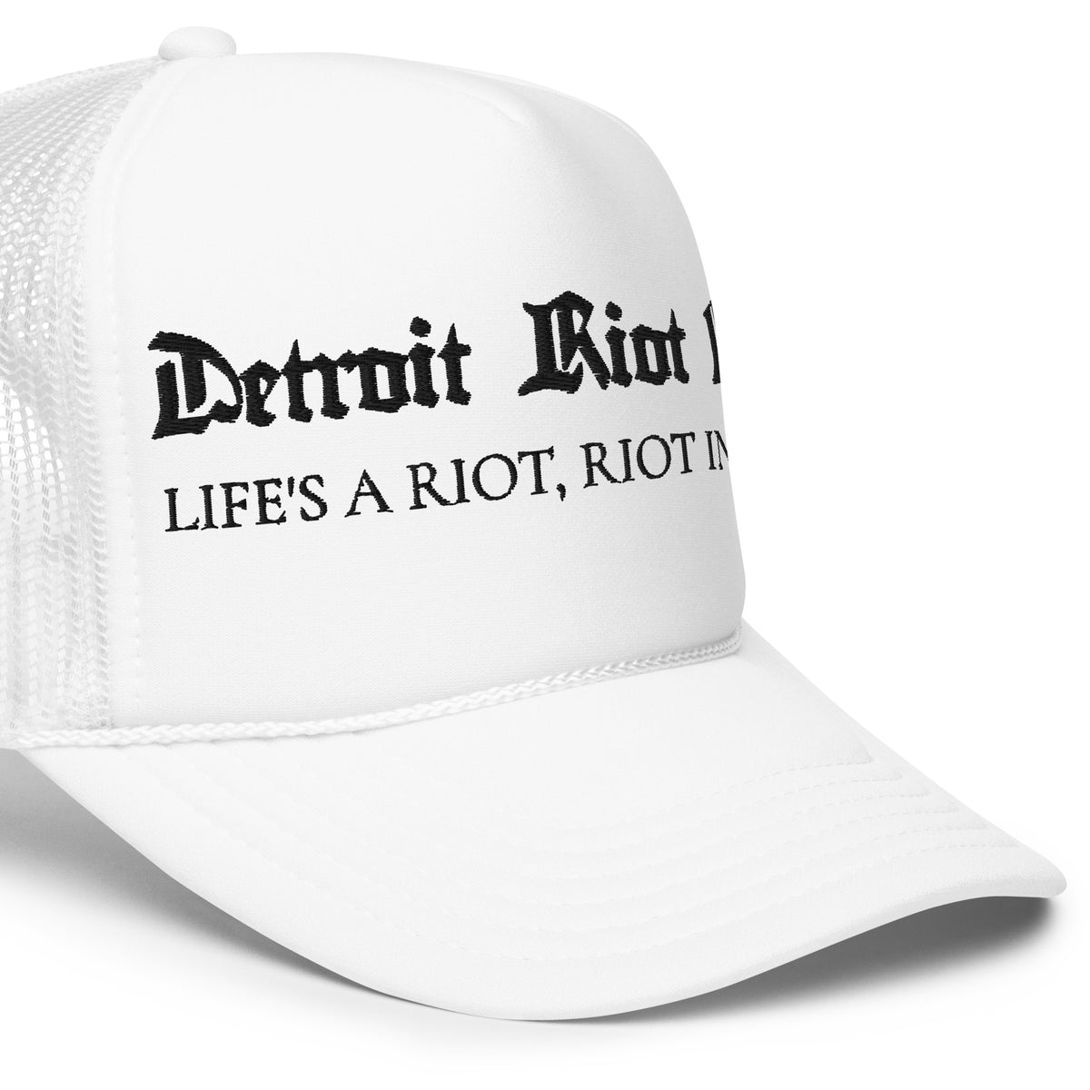 "Right-side crown detail of the Detroit Riot Club Motto Foam Trucker in white, highlighting the archival gothic embroidery, structured foam front, and mesh side panel construction."